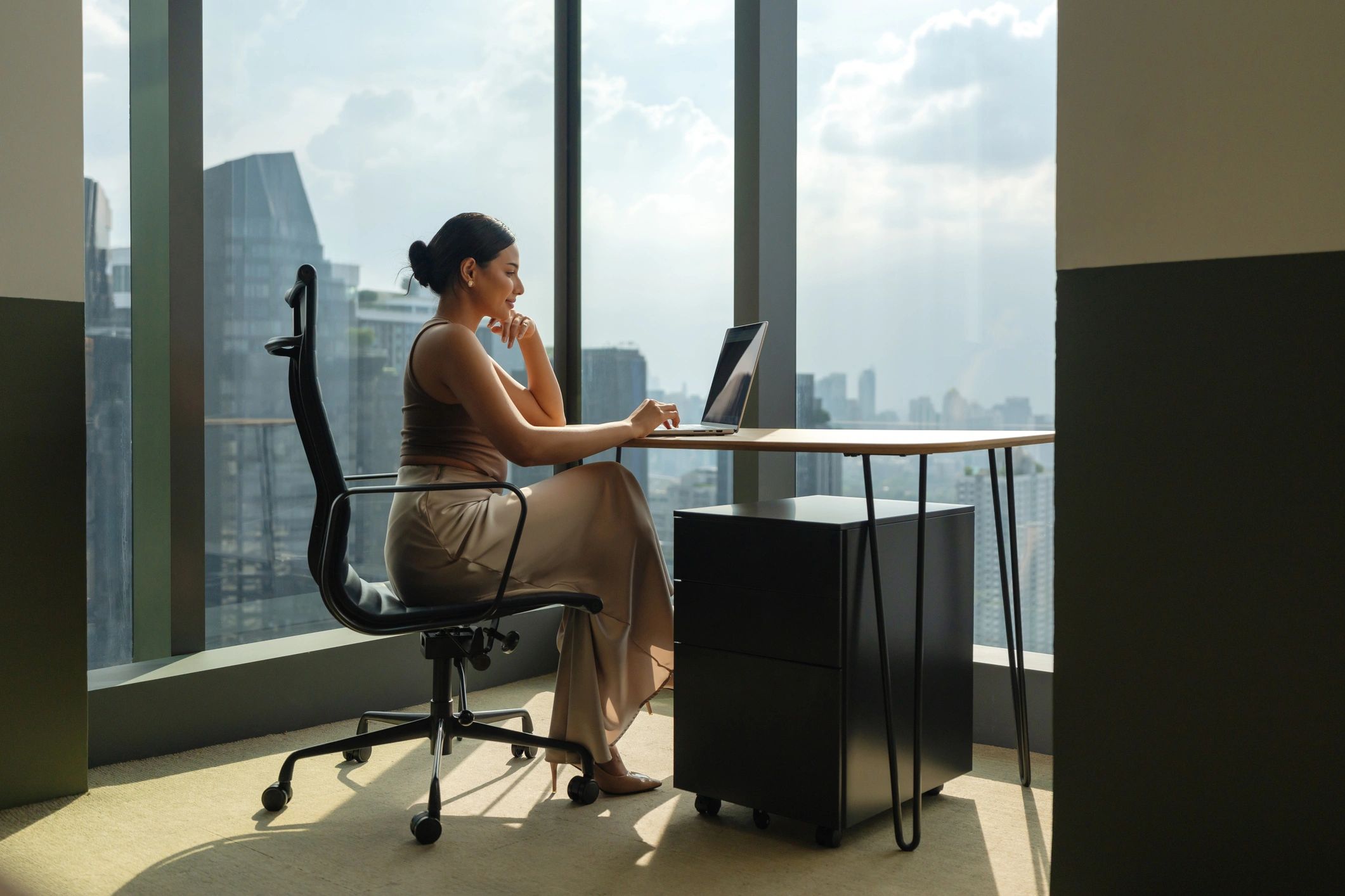Professional virtual assistant working at a laptop