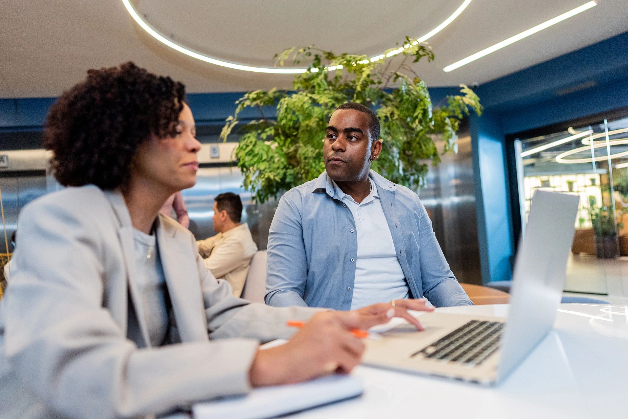 Business professionals collaborating on a laptop