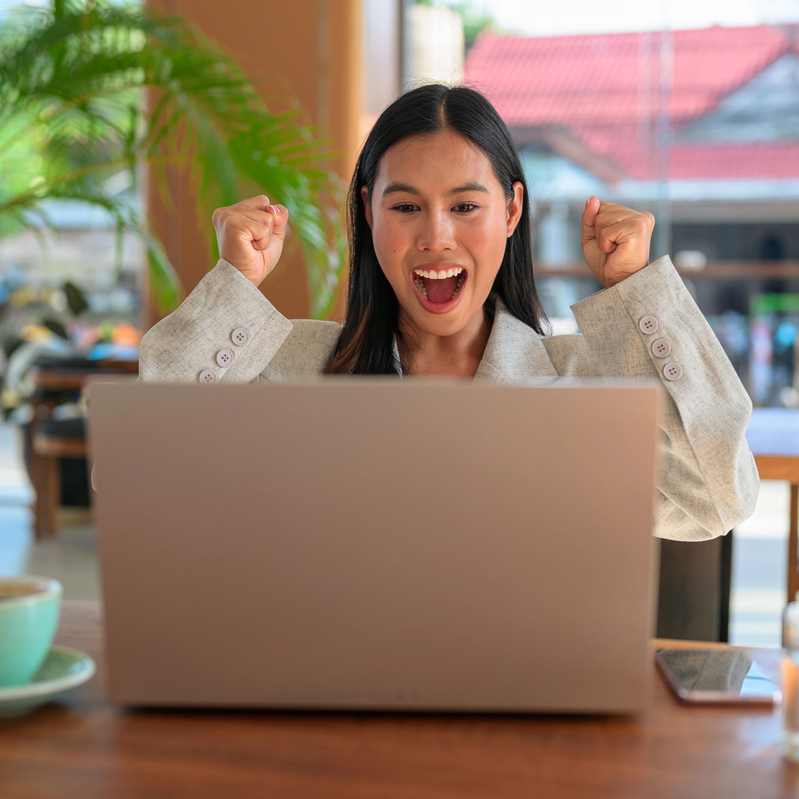 Young Asian virtual assistant working professionally on a laptop